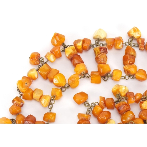 662 - Butterscotch amber coloured necklace and a bracelet, the necklace 50cm in length, approximate weight... 