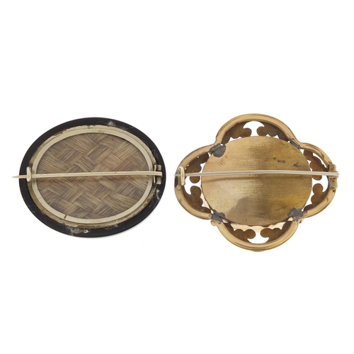 650 - Two Victorian mourning brooches including  one gilt metal and enamel, the largest 5cm wide