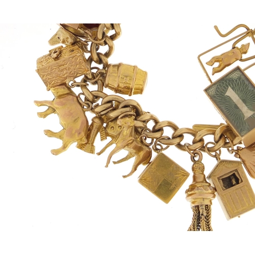601 - 9ct gold charm bracelet with a large selection of mostly 9ct gold charms including bird in a cage, f... 