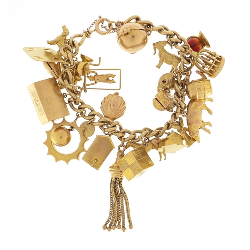 601 - 9ct gold charm bracelet with a large selection of mostly 9ct gold charms including bird in a cage, f... 