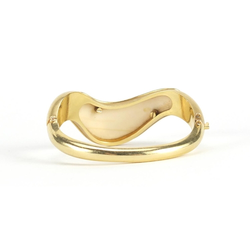 626 - 1970's modernist unmarked gold and ivory bangle, (tests as 18ct), 7cm wide, approximate weight 52.4g