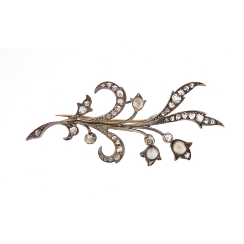 595 - Unmarked white metal diamond and pearl floral spray brooch, 5.5cm in length, approximate weight 4.6g