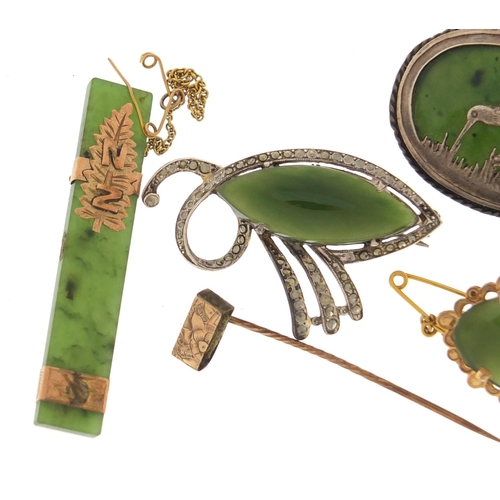 659 - Four jade brooches one with unmarked gold mount and a silver kiwi example, the largest 5.5cm in leng... 