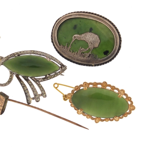 659 - Four jade brooches one with unmarked gold mount and a silver kiwi example, the largest 5.5cm in leng... 