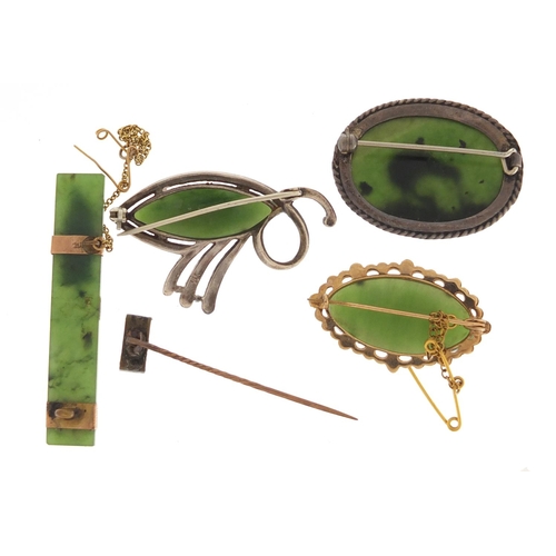 659 - Four jade brooches one with unmarked gold mount and a silver kiwi example, the largest 5.5cm in leng... 