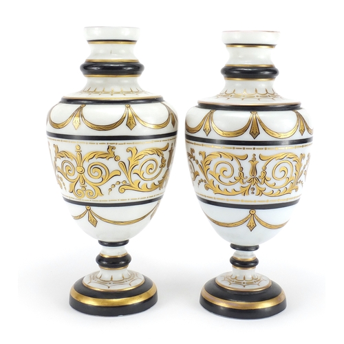 435 - Matched pair of 19th century white opaline glass vases gilded with foliate motifs, each 29.5cm high