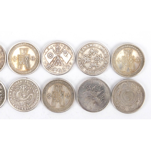 2575 - Twelve Chinese silver coloured metal coins including fatman design examples
