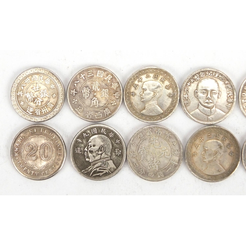 2575 - Twelve Chinese silver coloured metal coins including fatman design examples