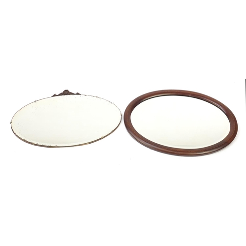 143 - Two oval wall hanging mirrors with bevelled glass, one with mahogany frame, the largest 71cm wide