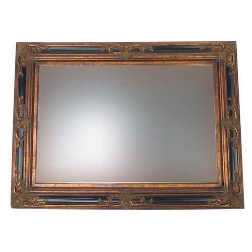 40 - Large rectangular wall hanging mirror with bevelled glass and black and gilt frame, 118cm x 86cm