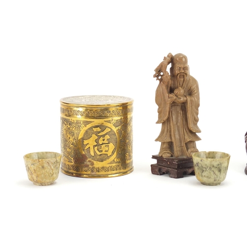 804 - Chinese objects including three carved stone tea bowls, a soapstone figure and brass cylindrical pot... 