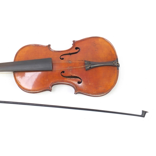 551 - Old wooden violin with bow and case, the back 37cm in length
