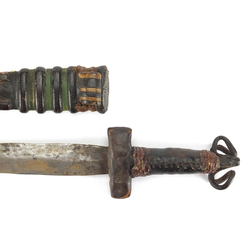 975 - Middle Eastern leather bound dagger with scabbard, 28cm in length