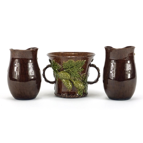 421 - Rye Hop Ware including a pair of vases and twin handled cup, the largest 10cm high