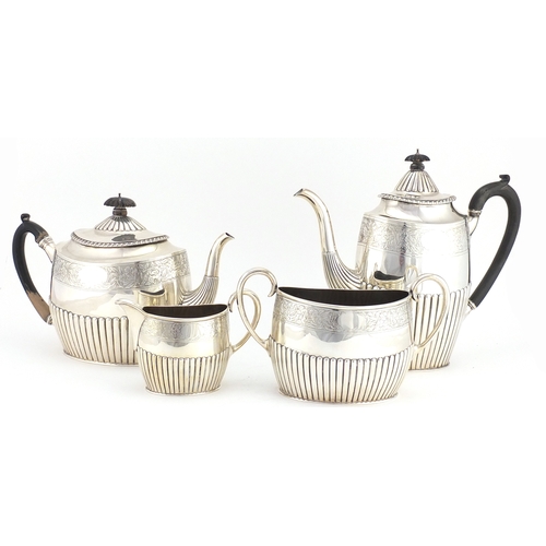 513 - Victorian silver four piece tea set with demi fluted body and engraved with flowers, by Walter & Joh... 