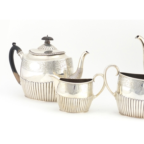 513 - Victorian silver four piece tea set with demi fluted body and engraved with flowers, by Walter & Joh... 