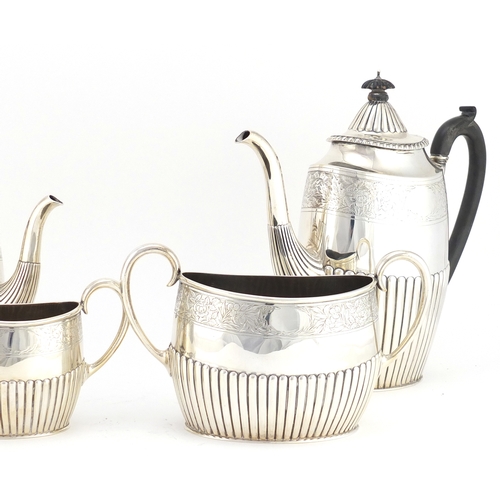 513 - Victorian silver four piece tea set with demi fluted body and engraved with flowers, by Walter & Joh... 