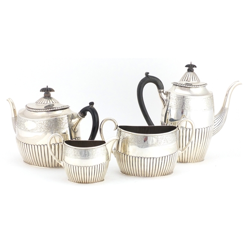 513 - Victorian silver four piece tea set with demi fluted body and engraved with flowers, by Walter & Joh... 