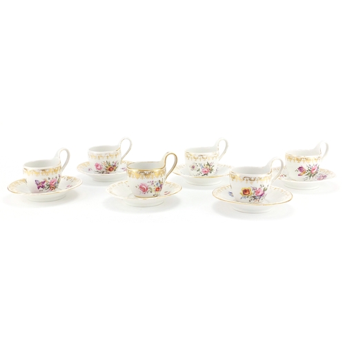 402A - Set of six 19th century Berlin cups and saucers, each hand painted with flowers below a gilt border,... 