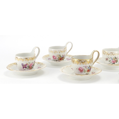 402A - Set of six 19th century Berlin cups and saucers, each hand painted with flowers below a gilt border,... 