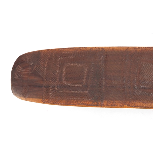 337 - Aboriginal parrying shield carved with tribal motifs, 77cm in length