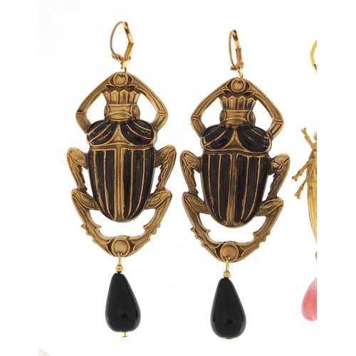 508 - Two pair of Egyptian Revival earrings including a pair of beetle design with drops, the largest 9.5c... 