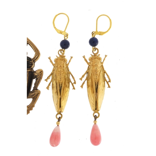 508 - Two pair of Egyptian Revival earrings including a pair of beetle design with drops, the largest 9.5c... 