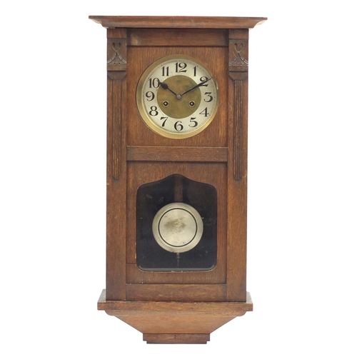 48 - Oak wall hanging striking clock with bevelled glass, 72cm high