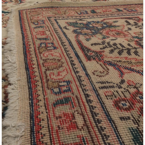 2035 - Rectangular Persian Tabriz carpet, the central field having foliate motifs onto an ivory ground with... 