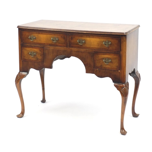 2069 - Walnut and mahogany cross banded low boy, fitted with four drawers on shell carved cabriole legs, 80... 