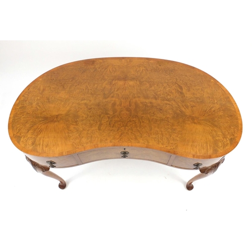 2044 - Waring & Gillow walnut kidney shaped dressing table with three drawers, on carved cabriole legs, 76c... 