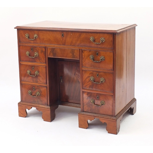 2076 - Victorian mahogany kneehole desk fitted with an arrangement of eight drawers and central cupboard do... 