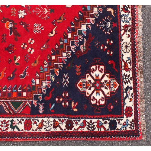 2050 - Persian Shriaz red and blue ground rug, decorated with birds and geometric design, 310cm x205cm