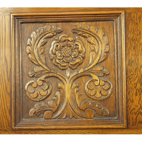 2092 - Jaycee oak bureau, carved with a crest and Tudor rose, fitted with a fall and fitted interior above ... 
