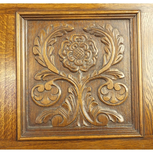 2092 - Jaycee oak bureau, carved with a crest and Tudor rose, fitted with a fall and fitted interior above ... 