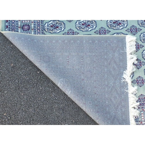2112 - Rectangular Bokhara design green ground floral rug, 230cm x 160cm