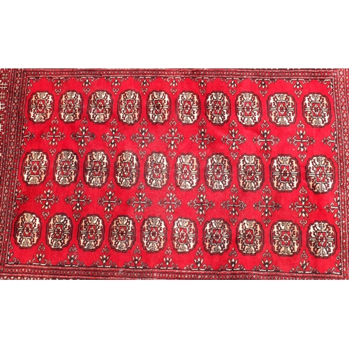 165 - Rectangular Bokhara red ground rug, 180cm x 125cm