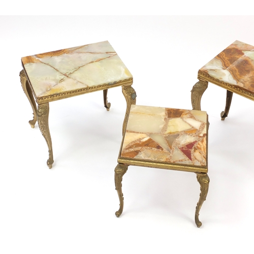 87 - Nest of three onyx and brass tables, the largest 45cm H x 51cm W 30cm D