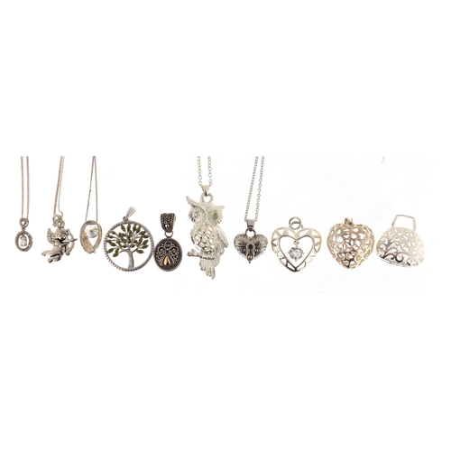 391 - Ten silver pendants, five with silver necklaces, approximate weight 50.8g