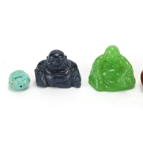 705 - Four Chinese carved stone figures of Buddha and a amber style brooch