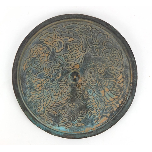 706 - Chinese bronze hand mirror decorated with dragons, 15.5cm in diameter