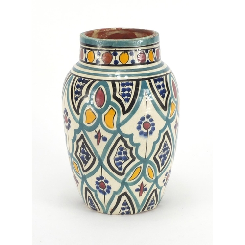 320 - Middle Eastern Iznik pottery design vase, hand painted with flower, 21cm high