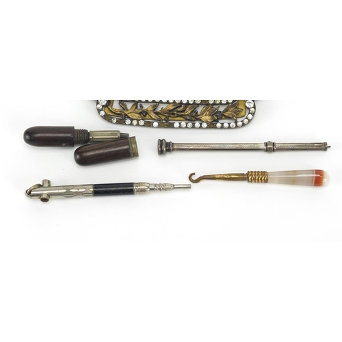 713 - Objects including a gilt metal buckle set with clear stones and a silver propelling pencil