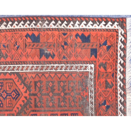 97 - Rectangular Persian Baluch red ground rug, 162cm x 93cm