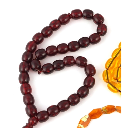 413 - Two amber coloured bead necklaces and two bracelets, the largest 76cm in length, approximate weight ... 
