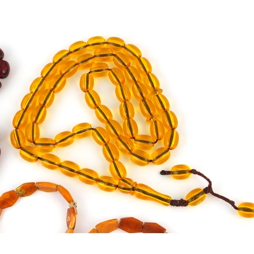 413 - Two amber coloured bead necklaces and two bracelets, the largest 76cm in length, approximate weight ... 