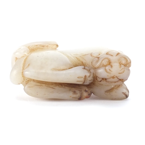 665 - Chinese white and russet jade carving of a lion, 7cm wide