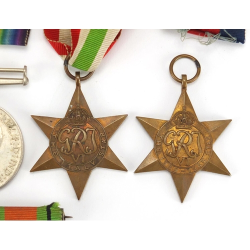842 - Four British Military World War II medals and Royal Dragoon cap badge