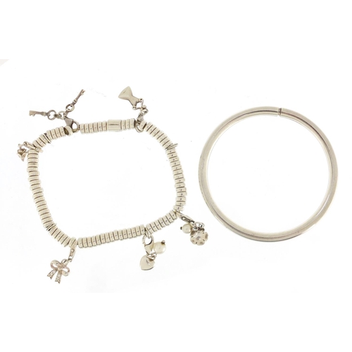 628 - Silver charm bracelet with charms and a white metal bangle, the charm bracelet 19.5g