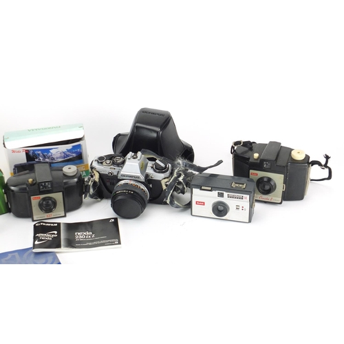 231 - Vintage and later cameras including Olympus OM10